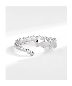 Close-up of silver shooting star open ring with a series of minimalist star patterns