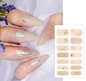 Macro detail of nude floral nail wraps with fine glitter and 3D wave patterns for manicure