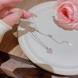 Pink heart pendant necklace with shimmering zircon accents on adjustable silver chain