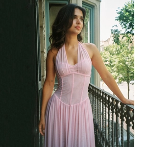 Detail view of pink halter neck pleated dress with corset bodice and airy skirt