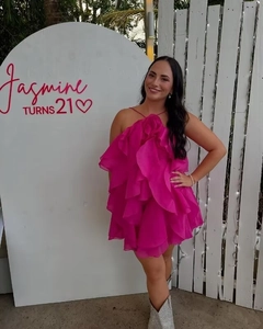 Detail of hot pink organza mini dress showing tiered ruffles and layered cake skirt texture