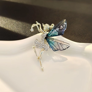 Elegant gold ballet girl brooch with blue gradient wings and white rhinestones