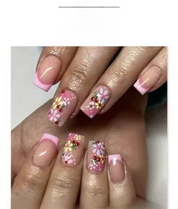 Close-up of pink French press-on nails with cute flower and cherry patterns