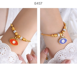 Detail of adjustable evil eye bracelets with orange and purple enamel charms and beads