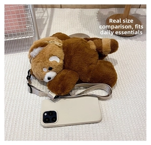Detail of red panda plush crossbody bag showing the zipper and adjustable strap