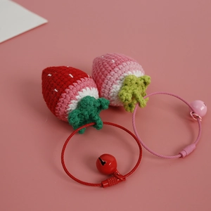 Handmade crochet strawberry keychain set in red and pink with metal bells and wire loops