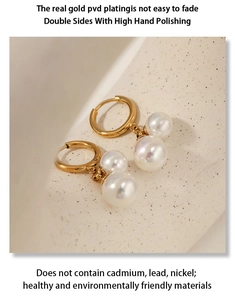 Detail of PVD gold plated earrings with white pearls and polished metallic finish
