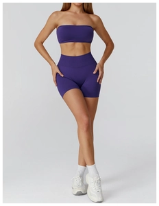 Detail of seamless purple yoga set featuring ribbed crop top and high waist shorts