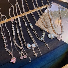 Detail of Korean style pearl necklace set with heart, butterfly and cherry charms