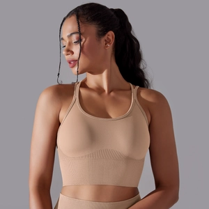 Close-up of seamless beige sports bra with wide ribbed elastic band and knit texture