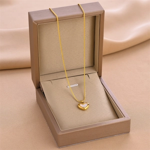 Elegant gold heart pendant necklace with white inlay shell in a beige gift box