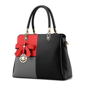 Women's minimalist color-block PU leather handbag with red bow and metallic charm