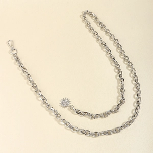 Detail view of silver punk chain belt with sun pendant and lobster clasp for dresses
