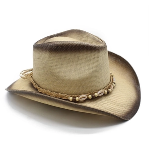 Close-up of western straw hat featuring gradient brim and seashell rope band detail