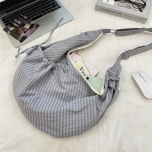 Detail of gray plaid nylon tote bag interior showing large capacity for books and phone