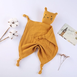 Detailed view of yellow cotton muslin baby security blanket with cat head and knots