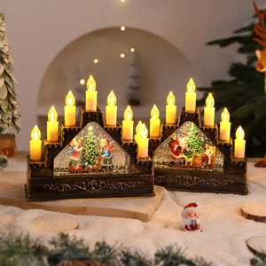 Detail of Christmas lantern with LED candle flame, snowy scene, and retro wood texture base