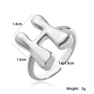 Macro detail of silver adjustable H-letter ring showing dimensions and weight metrics