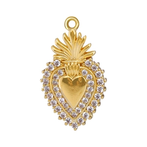 Detail of a luxury heart pendant with clear cubic zirconia pavé and golden finish