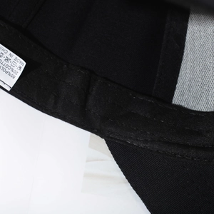 Classic black baseball cap detail showing premium polyester-cotton fabric and stitching