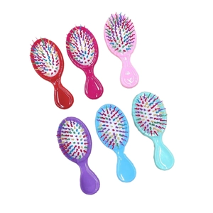 Set of 6 mini colorful rainbow hairbrushes with massage cushion on a white background