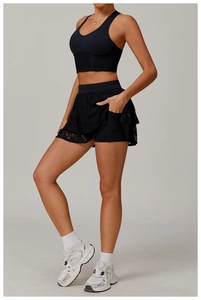 Detail of black lace yoga set showing V-neck vest and layered sports skirt with side pockets