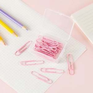 Detailed view of pink coated metal paperclips in a transparent plastic storage box