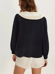 Detail of navy blue chiffon blouse showing back cut and double-layered white collar
