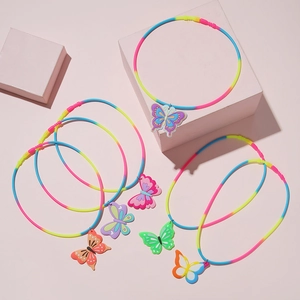 Detailed view of colorful butterfly pendants on rainbow gradient necklaces for kids