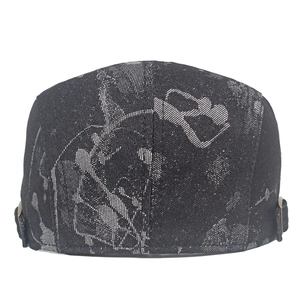 Macro detail of black jacquard beret with abstract patterns and metal buckle