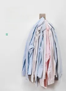 Detail shot of heavy-duty adhesive wall hook showing weight capacity with 12 shirts