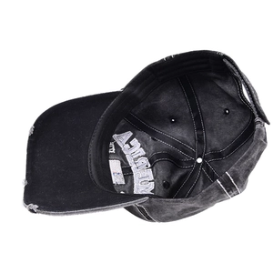 Close-up of distressed denim baseball cap interior with reinforced seams and embroidery