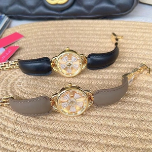 Detail of luxury women's watches featuring golden bow dials with crystal embellishments