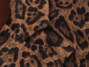 Close-up of leopard print faux suede fabric with soft texture for autumn winter coat