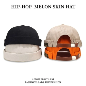 Unisex cotton docker caps in black, beige and orange with leather strap adjustment