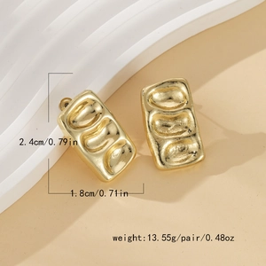 Detailed macro view showing gold wavy texture and dimensions of these French metal earrings