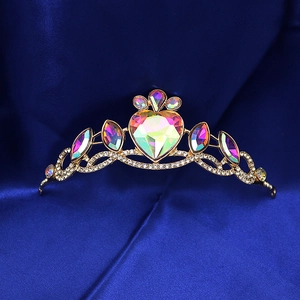 Sparkling gold princess crown with heart crystal for girls on dark blue silk fabric