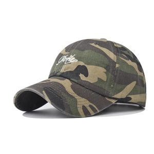 Close-up of vintage camo baseball cap featuring white smile embroidery and cotton twill texture