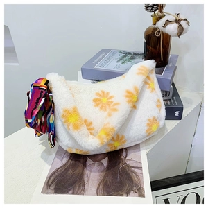 Detail of white plush shoulder bag with orange daisy pattern and decorative silk scarf