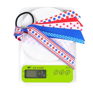 Close-up of patriotic US flag hair bow with stars and stripes showing weight 10.2g