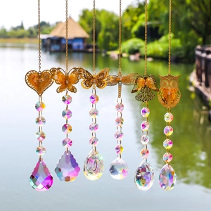 Detailed outdoor view of colorful crystal suncatchers with golden animal metal ornaments