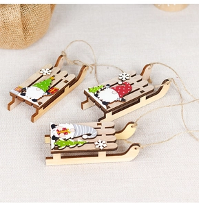 Three wooden Christmas gnome sleigh ornaments with snowflakes and hanging ropes