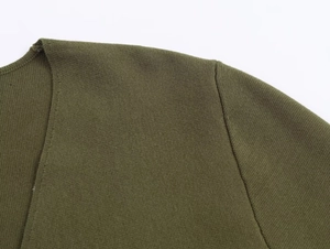 Detail of army green knitted v-neck cardigan showing fine stitching and shoulder seams