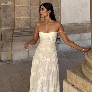 Detailed view of elegant ivory butterfly jacquard fabric on a slim fit maxi dress