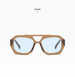 Detail showing retro brown geometric sunglasses frame with light blue lenses and double bridge