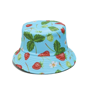 Close-up of strawberry print patterns and woven fabric texture on a bucket hat