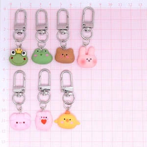 Set of 7 cute resin animal keychains featuring pig, rabbit, and frog with size ruler scale