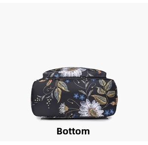 Detailed bottom view of black floral backpack made of durable nylon fabric