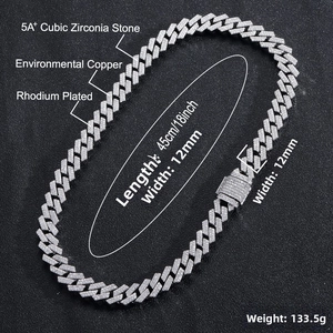 Detail of 12mm silver Cuban link chain with double row zircon stones on black background