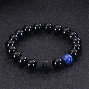 Macro detail of Gemini beaded bracelet with black onyx and tiger eye natural stones
